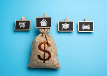 A burlap money bag with a dollar sign sits in front of four small blackboards showing icons for shopping, a house, education, and a car, all on a blue background. | MyWebInsurance